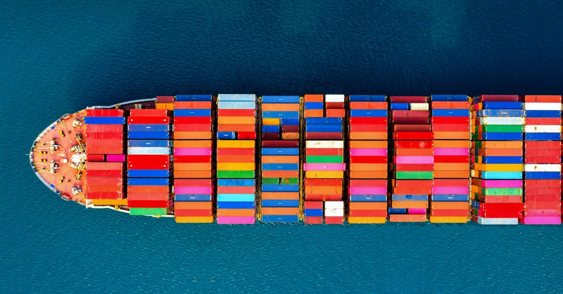 Aerial view of container cargo ship in sea.